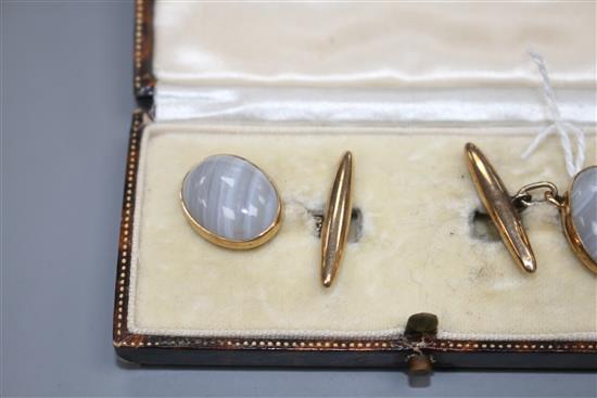A pair of 9ct and cabochon grey banded agate set cufflinks, agate length 16mm, gross weight 7.7 grams.